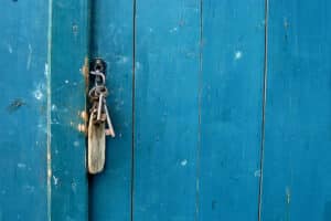 A set of house keys in the lock of a front door